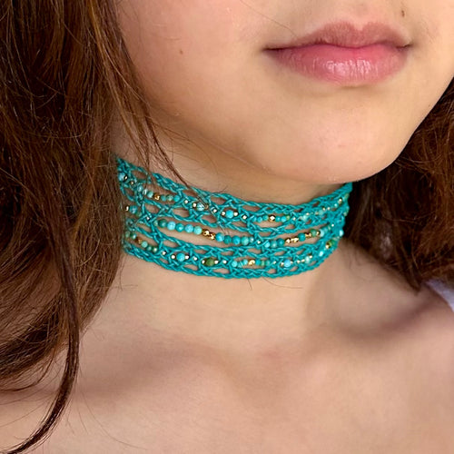 Model is wearing Spririted Grace choker in turquoise finish cord.  The choker is embellished with Turquoise gemstone and 24k gold plated beads